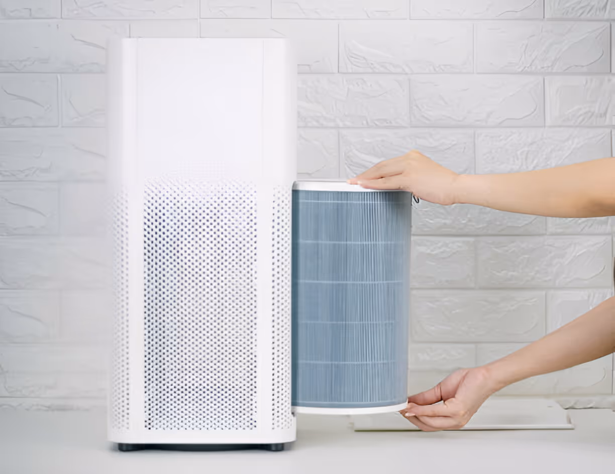 White air purifier with blue filter being adjusted by hands
