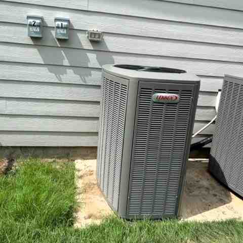 modern energy efficient central air conditioner unit installed outside a clean residential home modern energy efficient central air conditioner unit installed outside a clean residential home