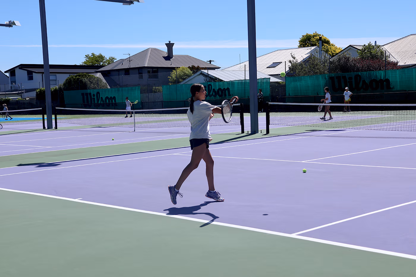 A young player training on court at the Waimairi Tennis Club - great forehand!