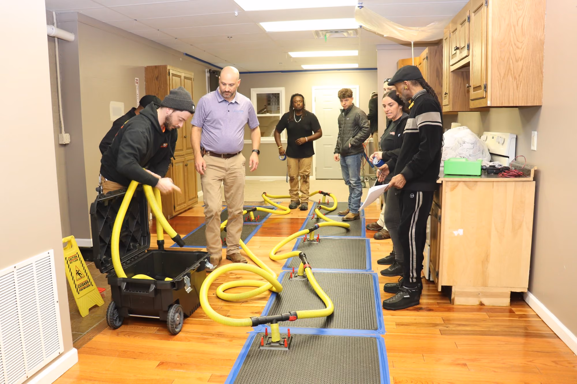 Flood house kitchen drying setup with an Injectidry system during a live water-loss simulation
