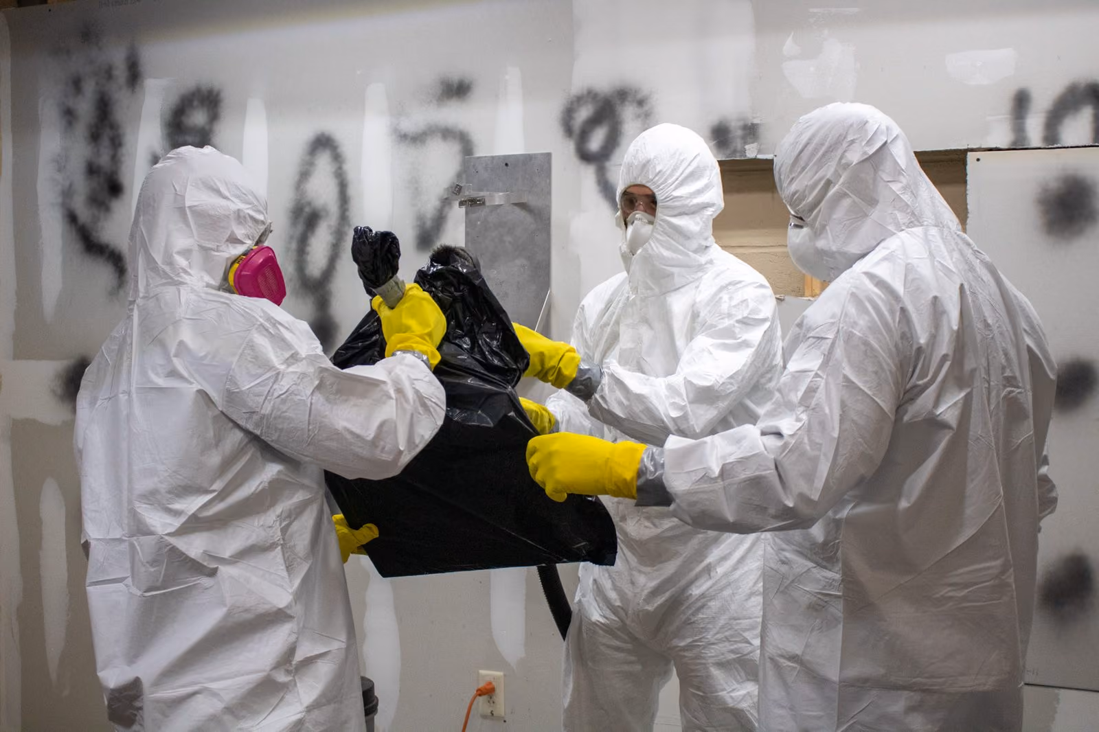 AMRT students remediating mold to the S520 standard in full PPE