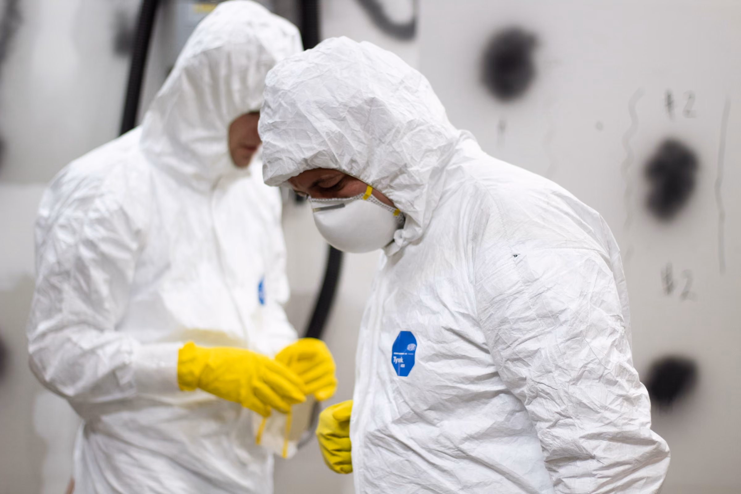 Technicians donning PPE and respirators correctly