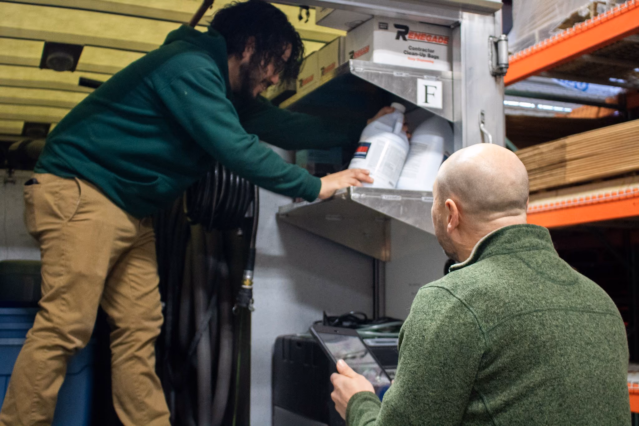 Technicians pulling supplies from the equipment truck for a job