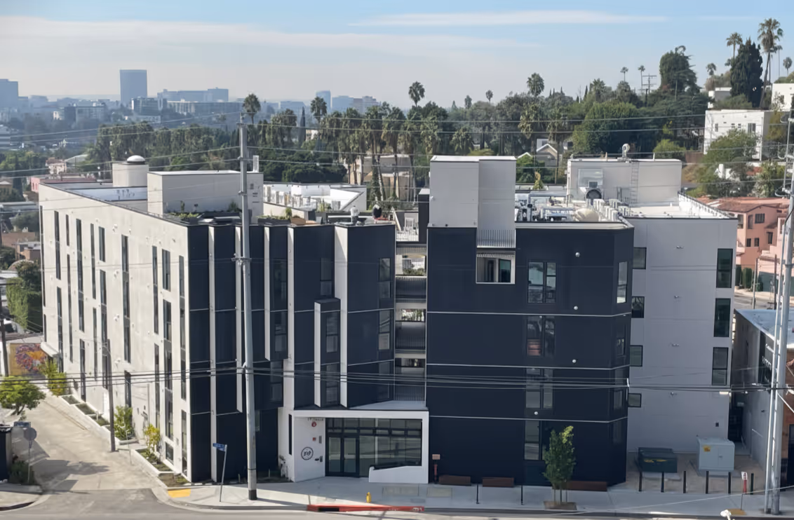 Modern four-story apartment building in Silver Lake, Ca with black and gray exterior panels and large windows