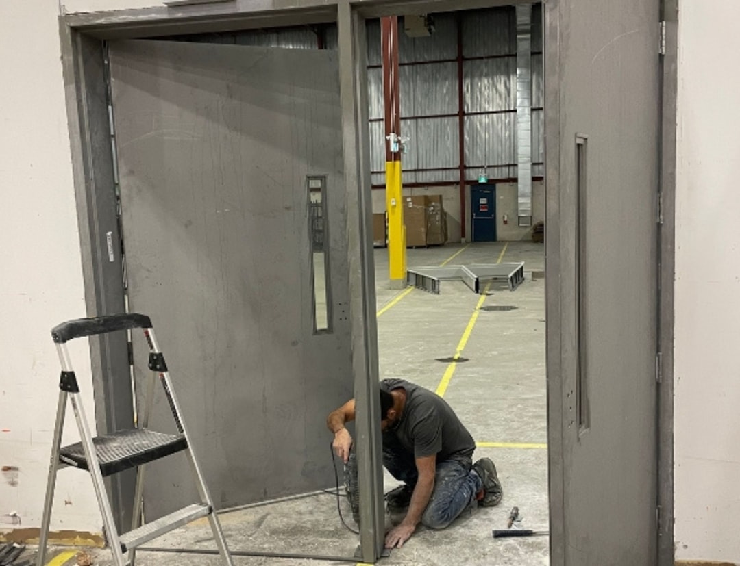 Professional installer measuring a rough opening for a prehung door - cost to install prehung entry door
