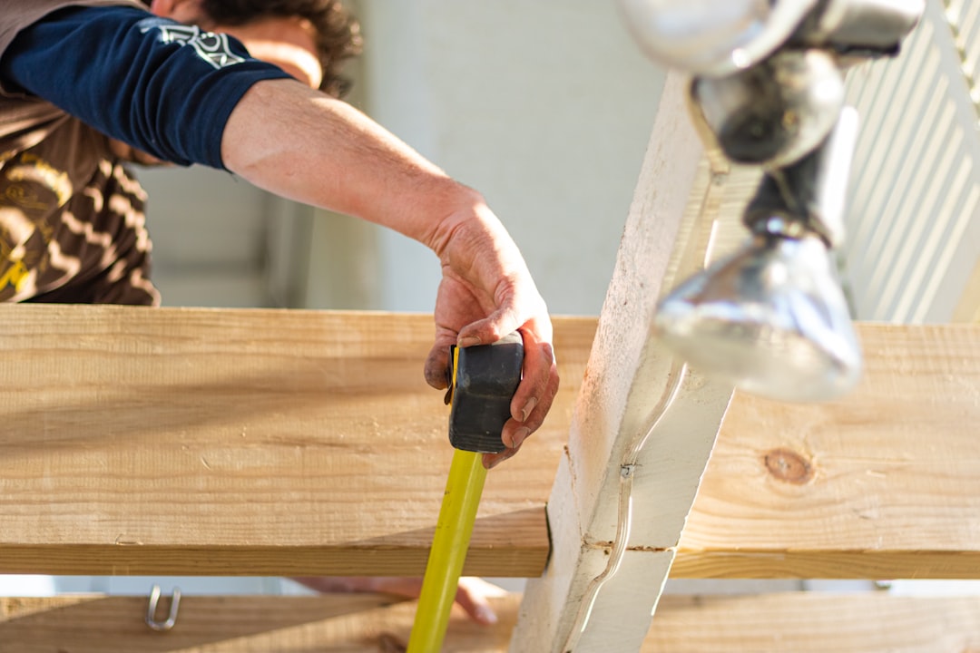 a contractor measuring a window frame from the exterior a contractor measuring a window frame from the exterior