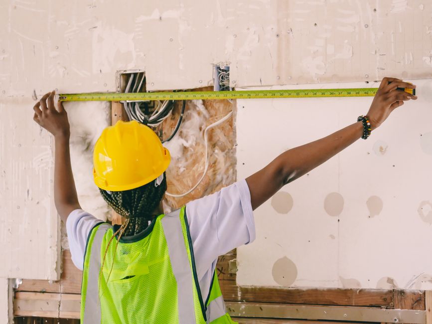A contractor measuring a window frame accurately - Double hung window install A contractor measuring a window frame accurately - Double hung window install