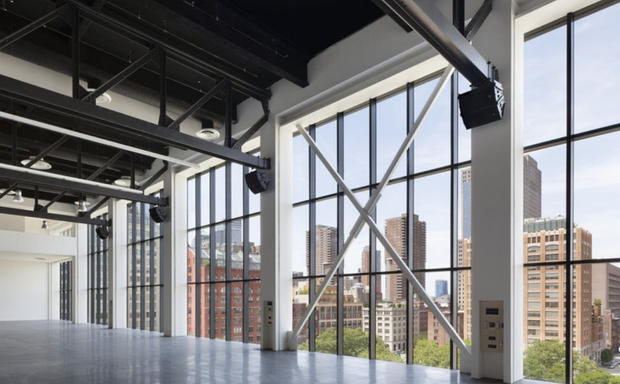 Loft-style event space with high ceilings and large windows at Spring Studios NYC.