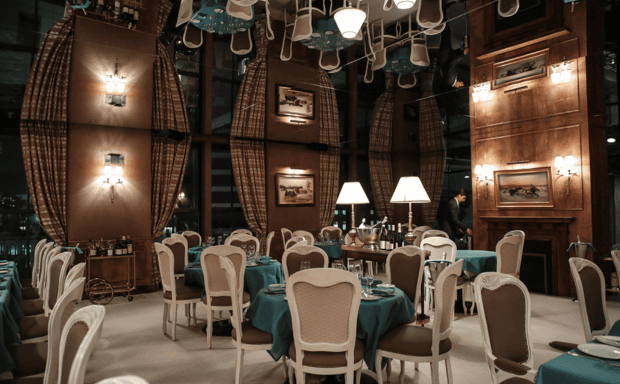 Gala dinner setup at Spring Studios New York with long tables and city views