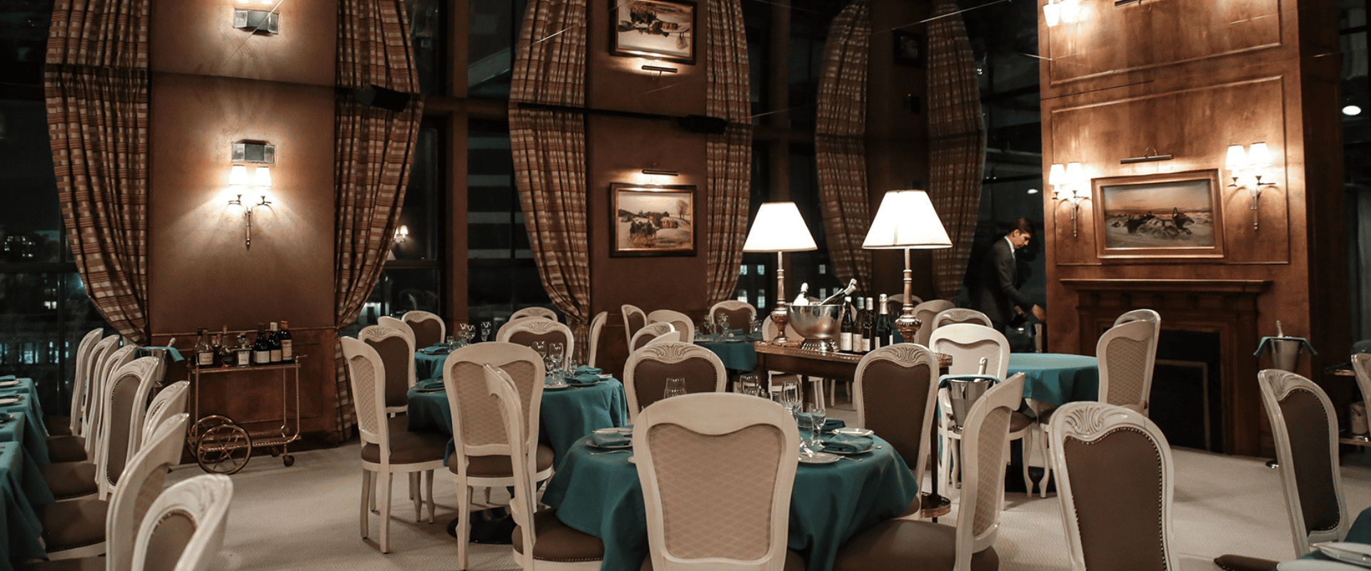 Private dining table setup on the rooftop terrace at Spring Studios with views over Tribeca and the Hudson River at sunset