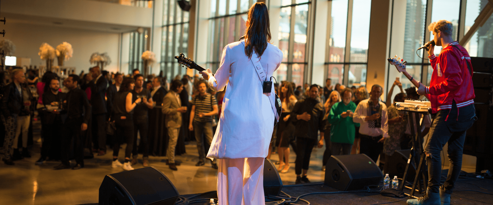 Multi-level guest route connecting gallery, studios, and rooftop during a cultural event.