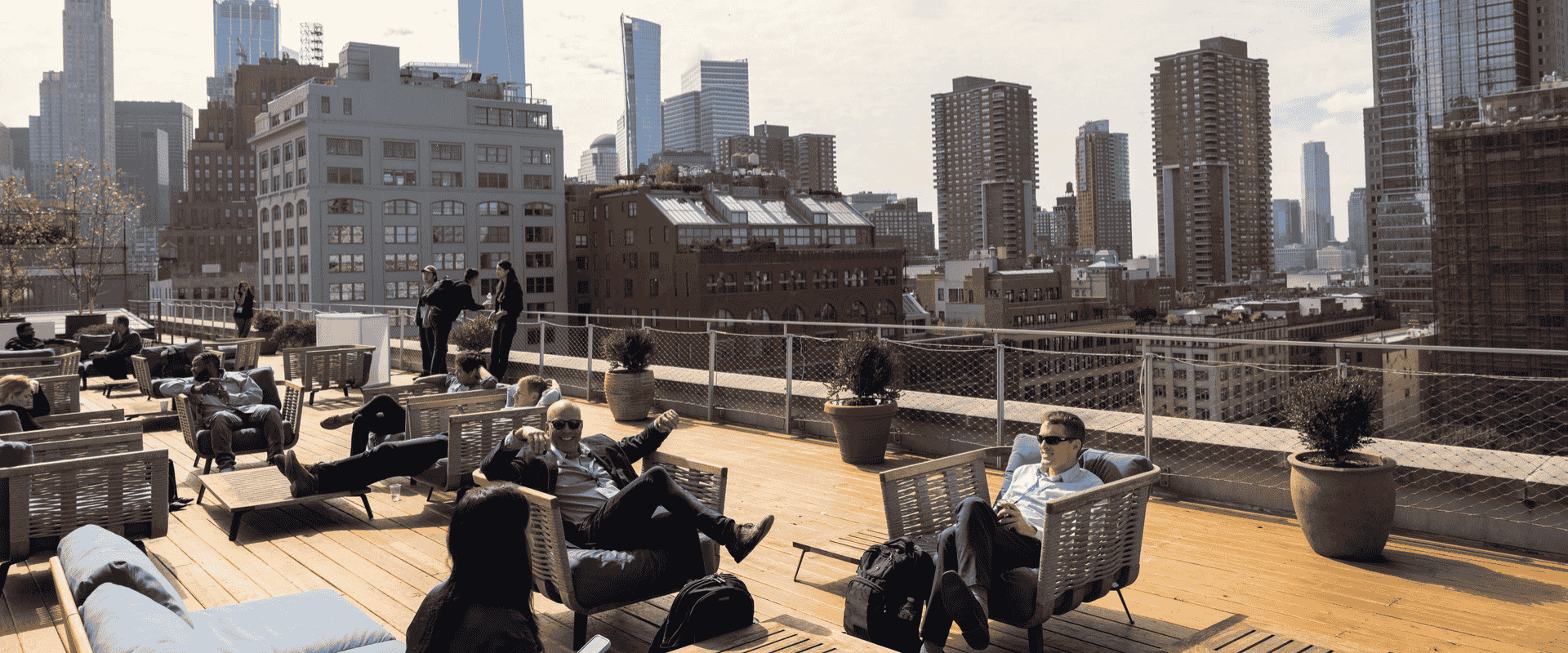 Urban rooftop terrace with seating and panoramic skyline backdrop