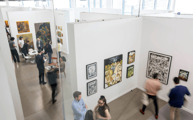Contemporary art gallery with visitors viewing framed artworks.