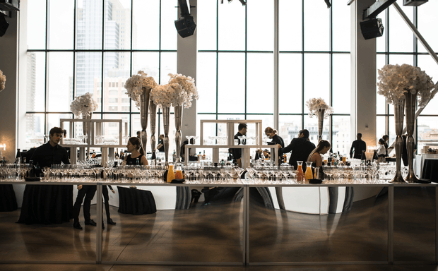 Elegant indoor event setup with tables and glassware
