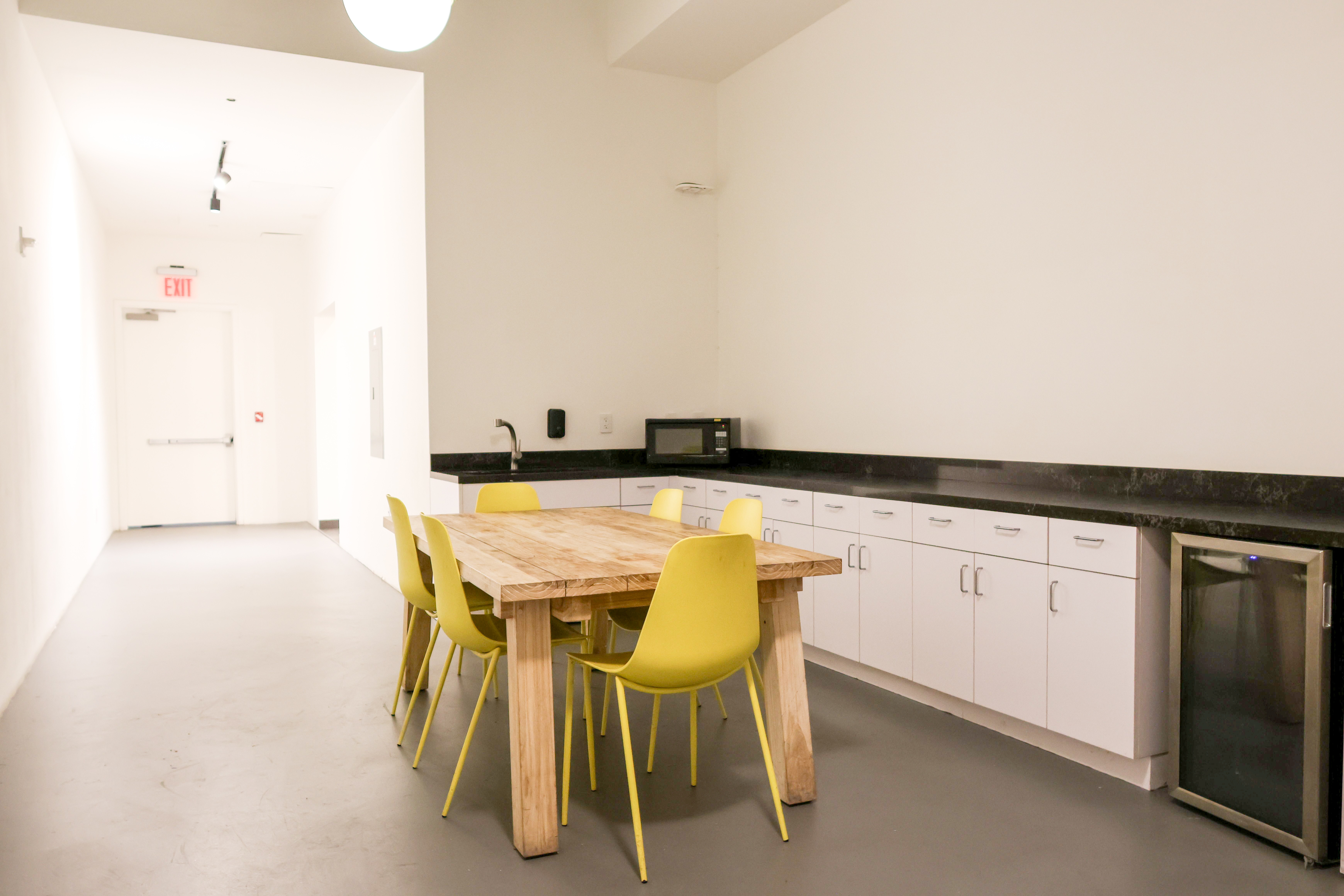 Simple modern table in the center of a clean, open studio.