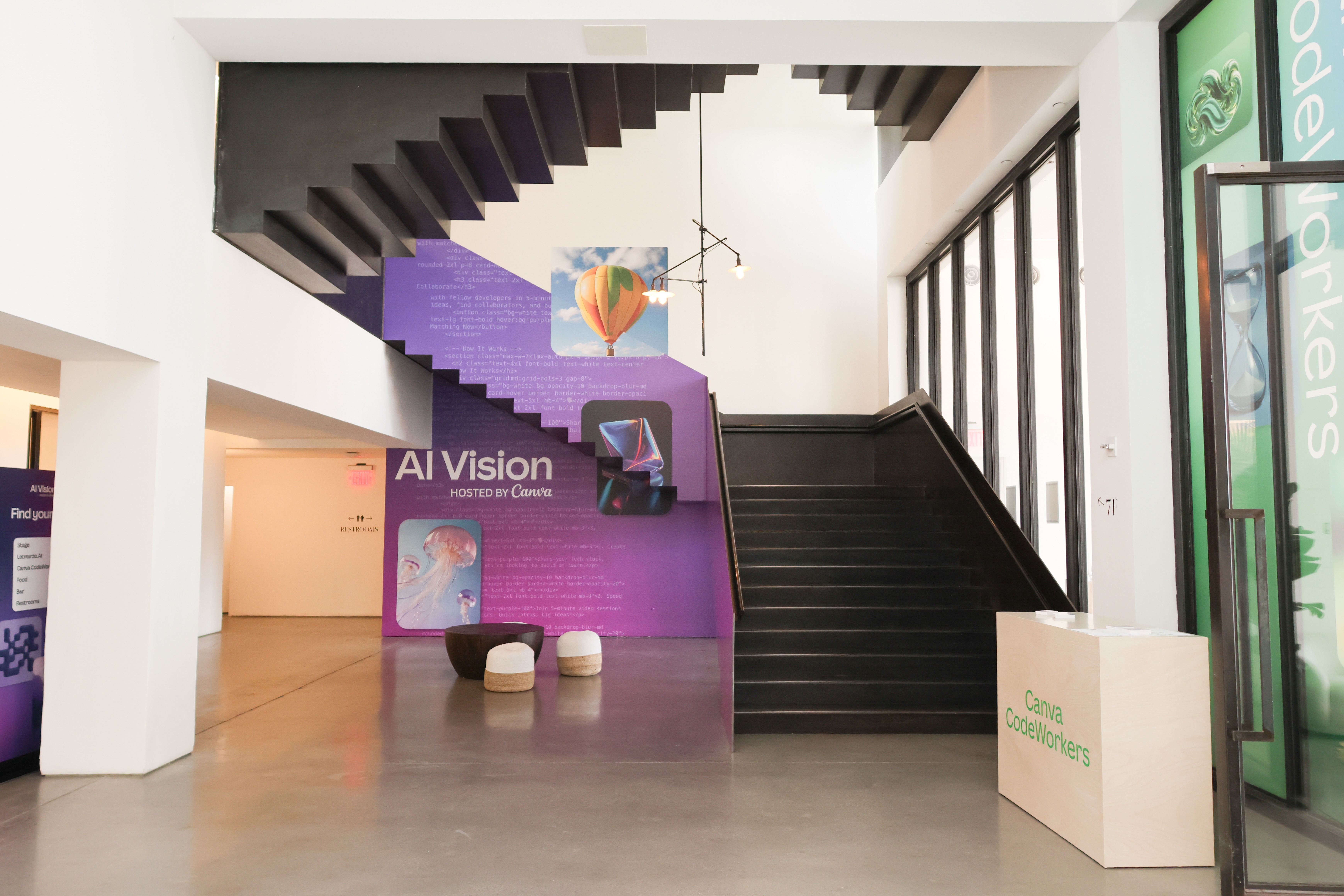 Modern black staircase and purple “AI Vision by Canva” event branding installation.