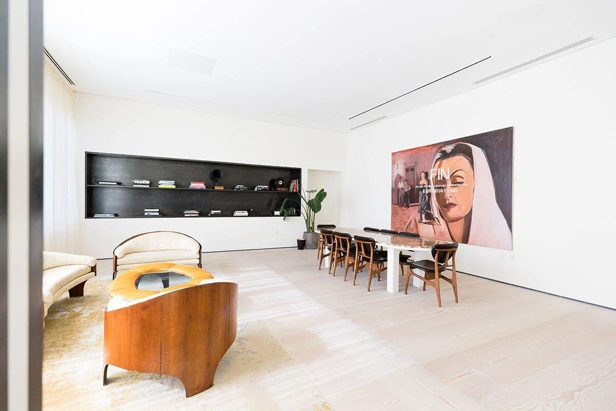 Contemporary seminar room with polished marble table and neutral tones.