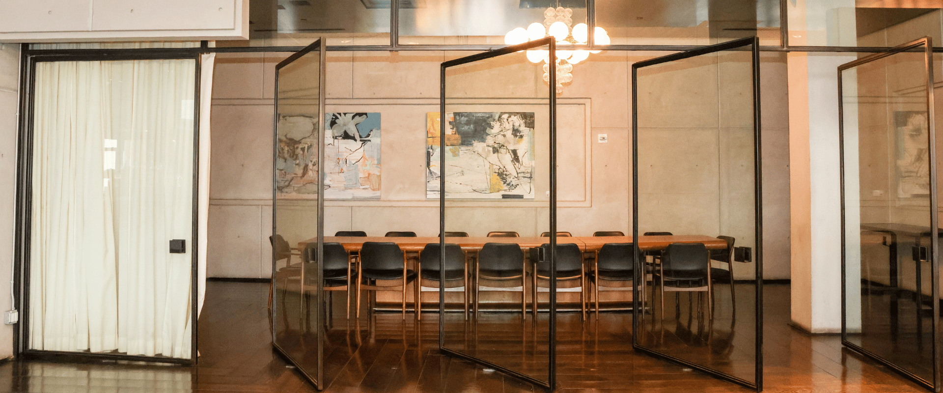 An upscale private event space with polished dark wood floors