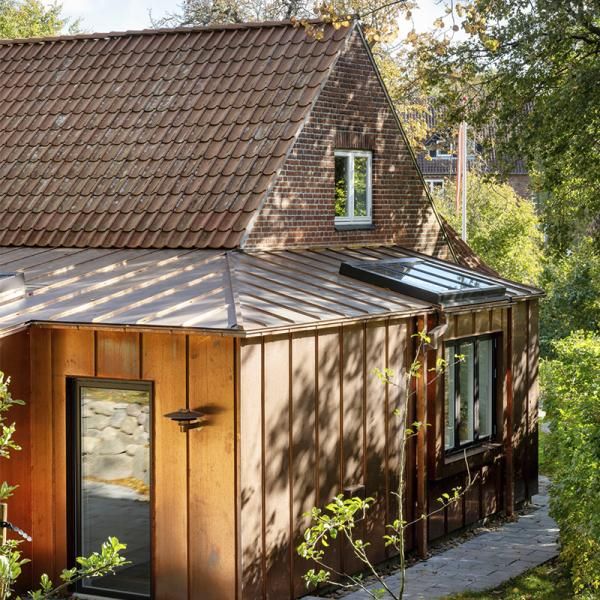 A small wooden house with a metal roof.