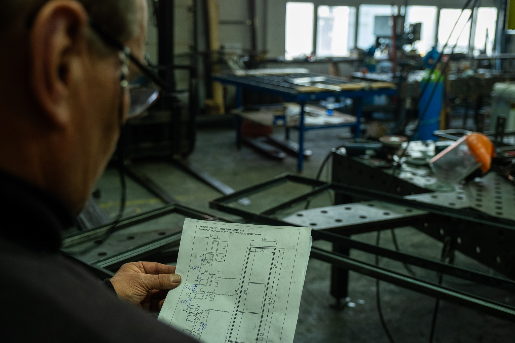 Checking a technical drawing in the Kraków workshop