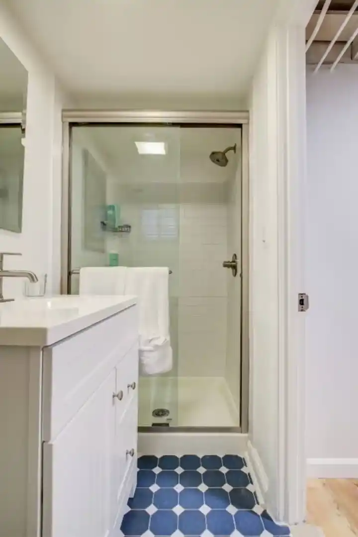 a bedroom with a window and a desk