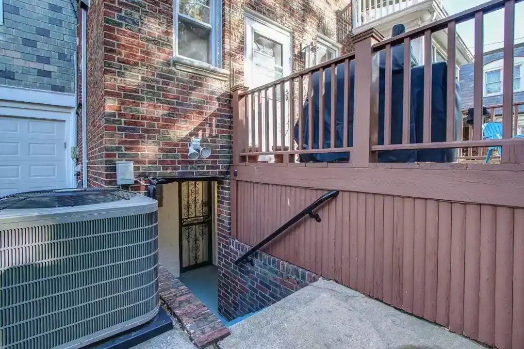 a brick building with a fence and a gate