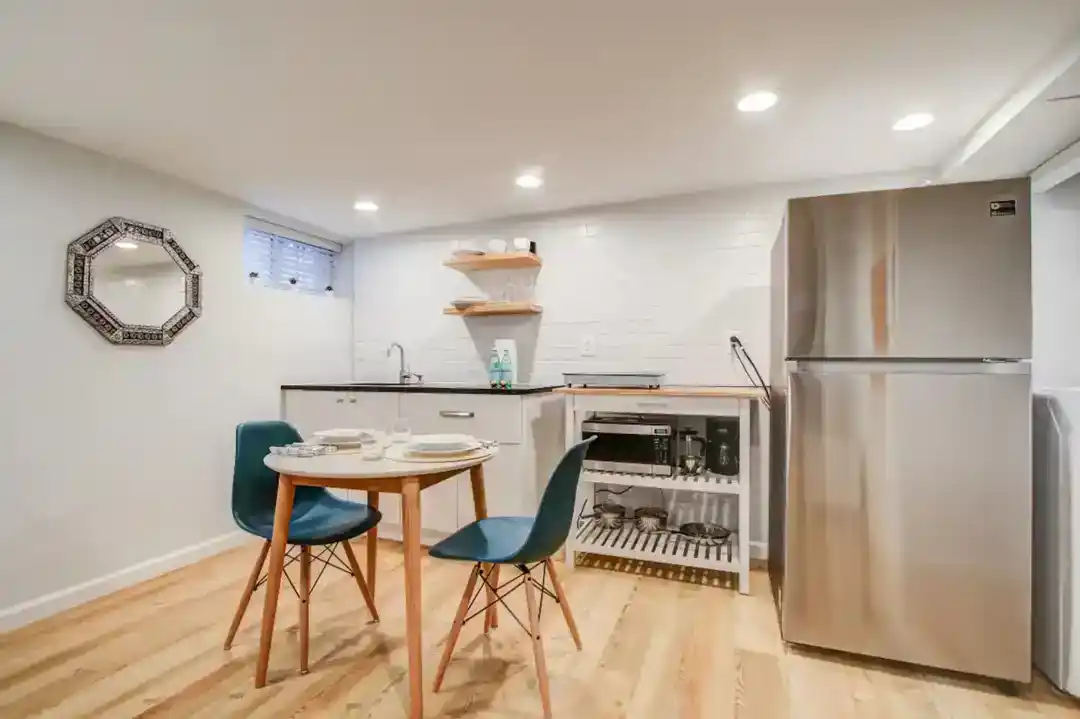 a kitchen with a fridge and a table