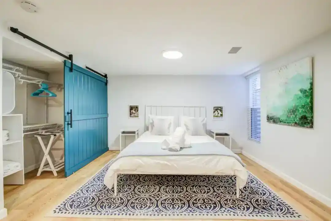 a bedroom with a bed and a blue door