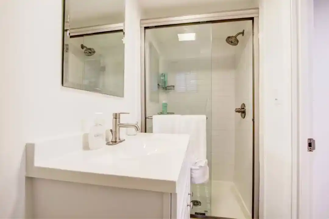 a bathroom with a glass shower door