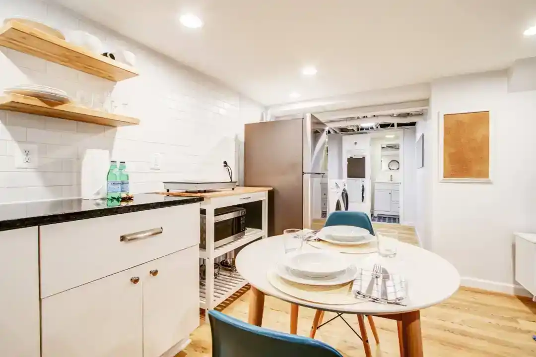 a kitchen with white cabinets and a stove