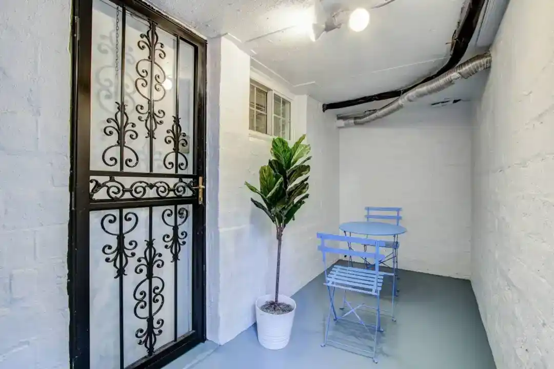 a balcony with a table and chairs