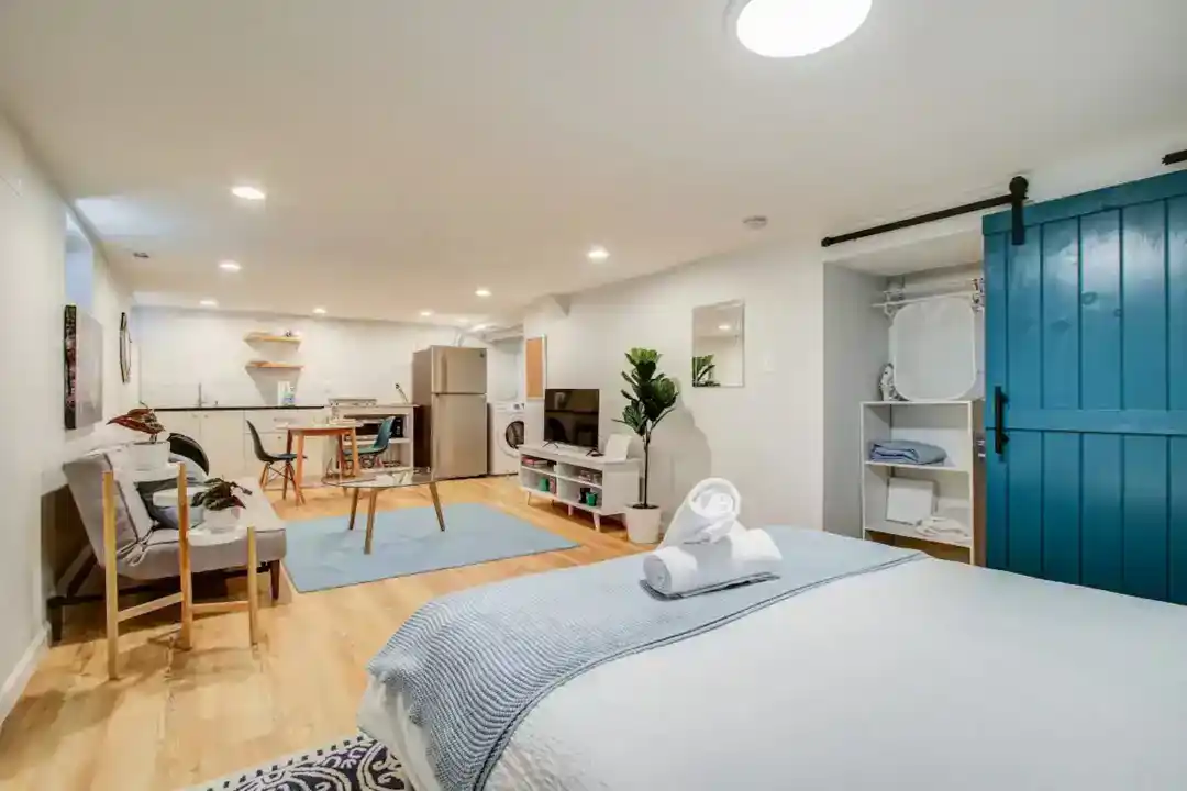 a living room with a TV and a plant