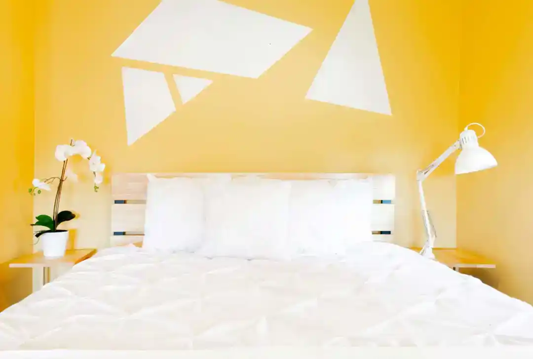 A townhouse for rent in Washington DC with a bedroom furnished with a bed and a television on the wall