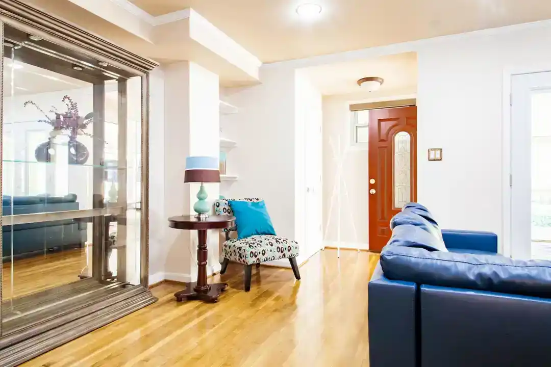 A charming townhouse in Washington DC with a living room including a blue couch and a table