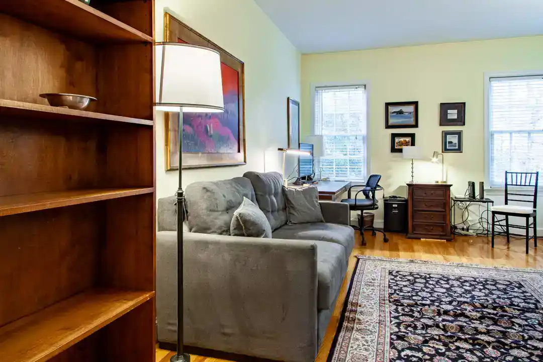 a cozy living room with a couch and a lamp