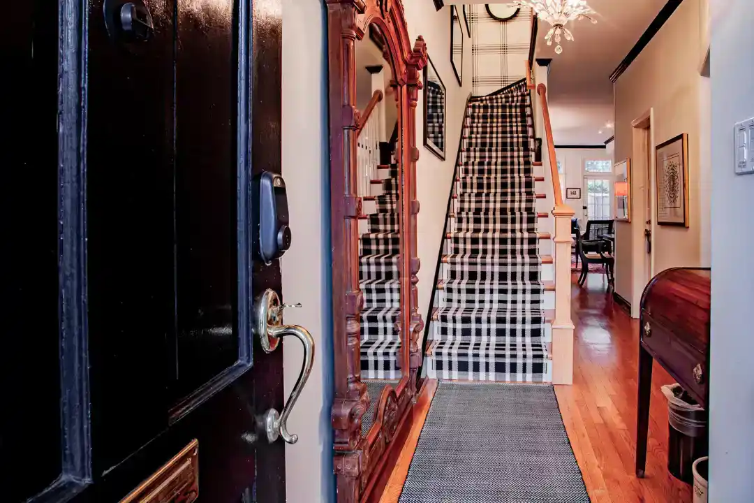 a grand hallway with a door and a chandelier