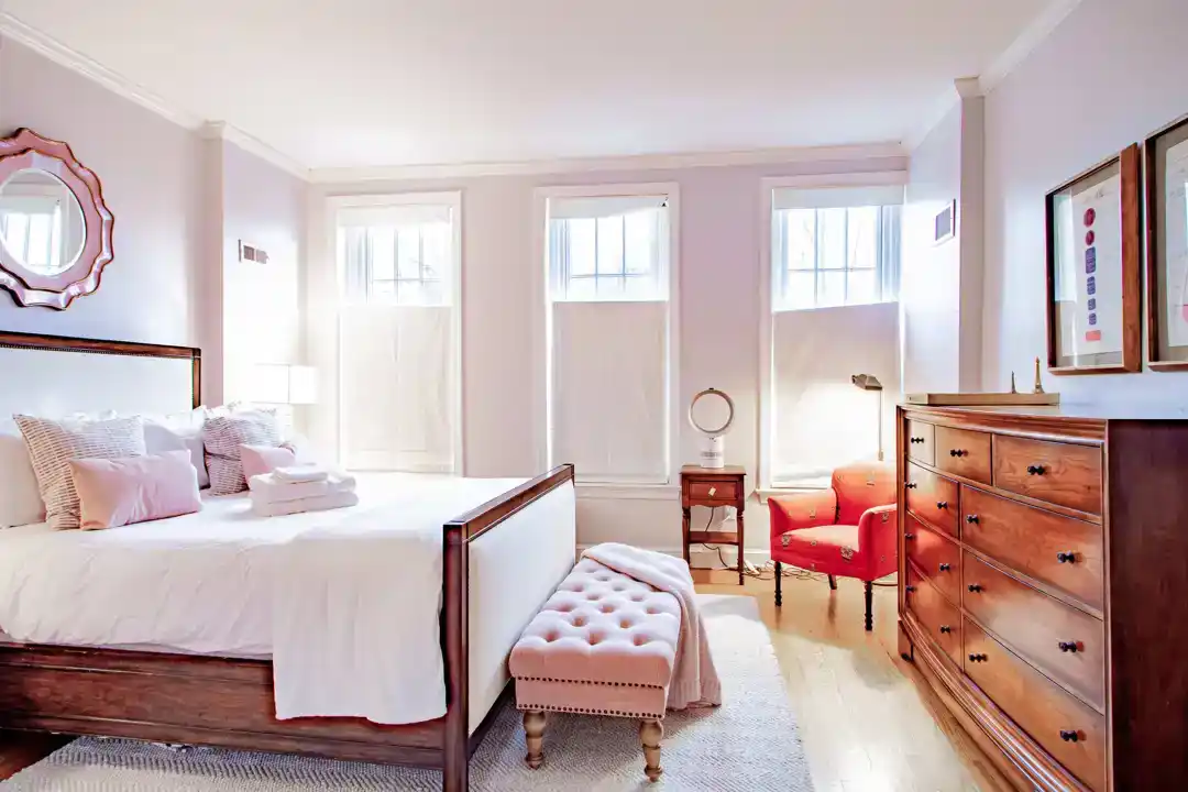 a romantic bedroom with a bed and a mirror