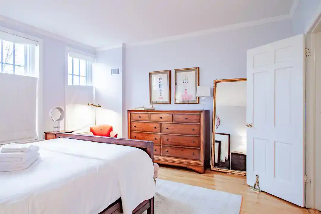 a comfortable bedroom with a bed and a dresser