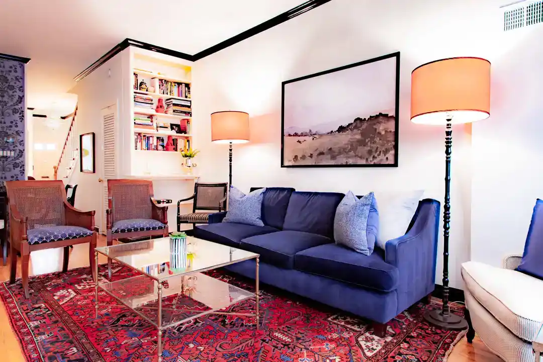 a trendy living room with a blue couch