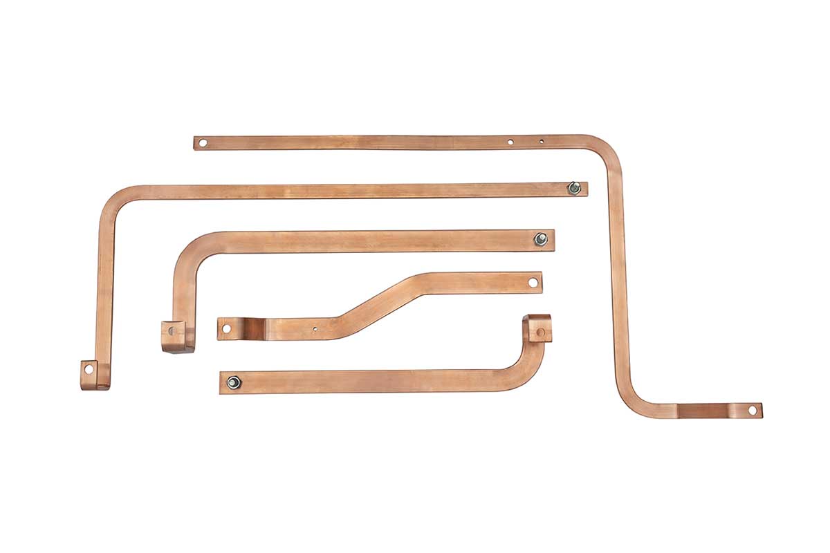Five custom-shaped copper busbars with holes and attached nuts, arranged on a white background.