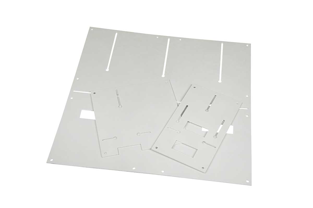 Three white rectangular panels with various slots and holes, arranged overlapping on a white background.