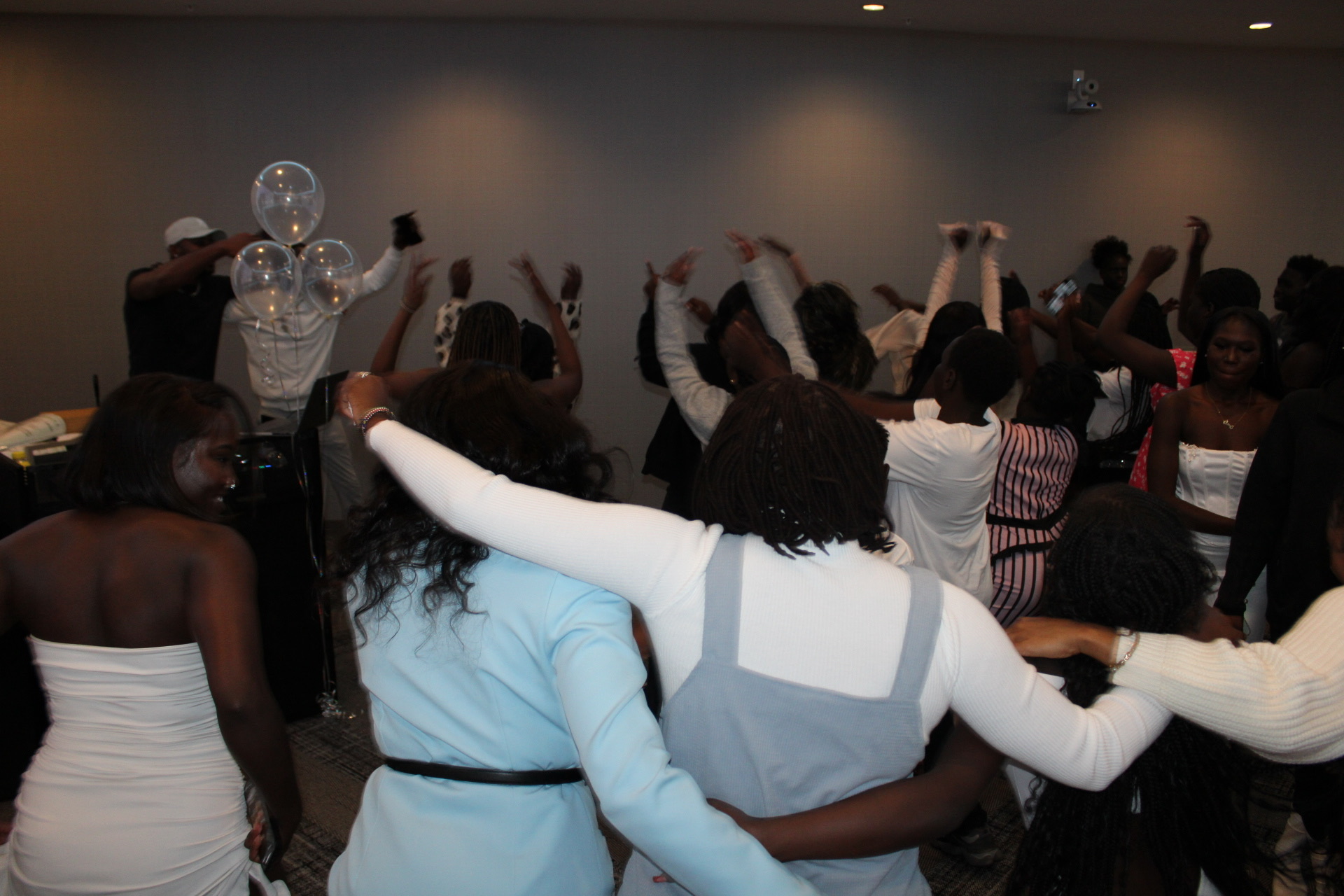 Group dancing at Frosty Fest in circle, arms around one another