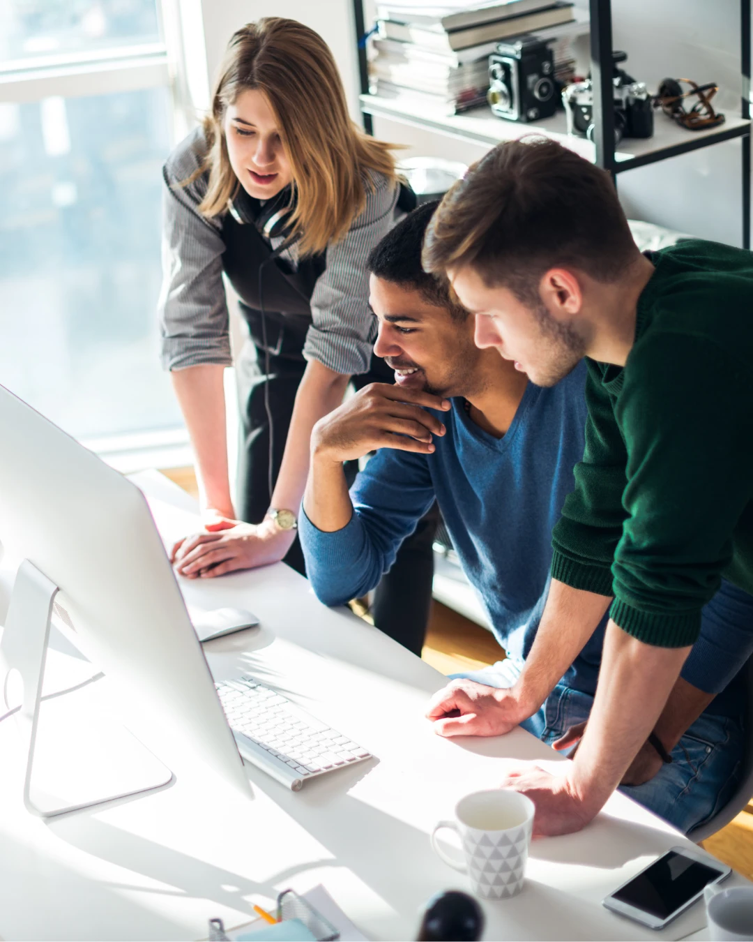 Team planning a B2B SaaS
paid media strategy around
campaign creative and landing
page layouts