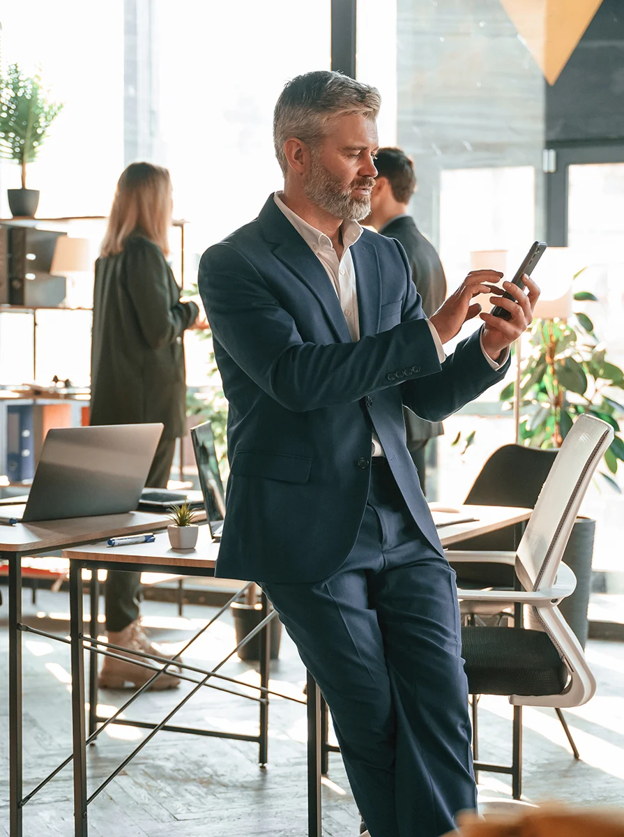 Business professional using a smartphone in a cafe