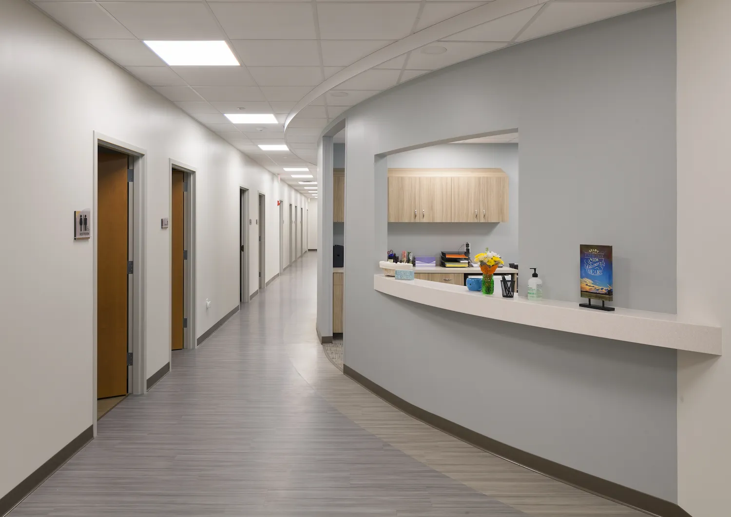 Hallway with curved bulkhead detail at St. Elizabeth OB/GYN and Pediatric Care in Lawrenceburg, renovated by Perry Contracting.