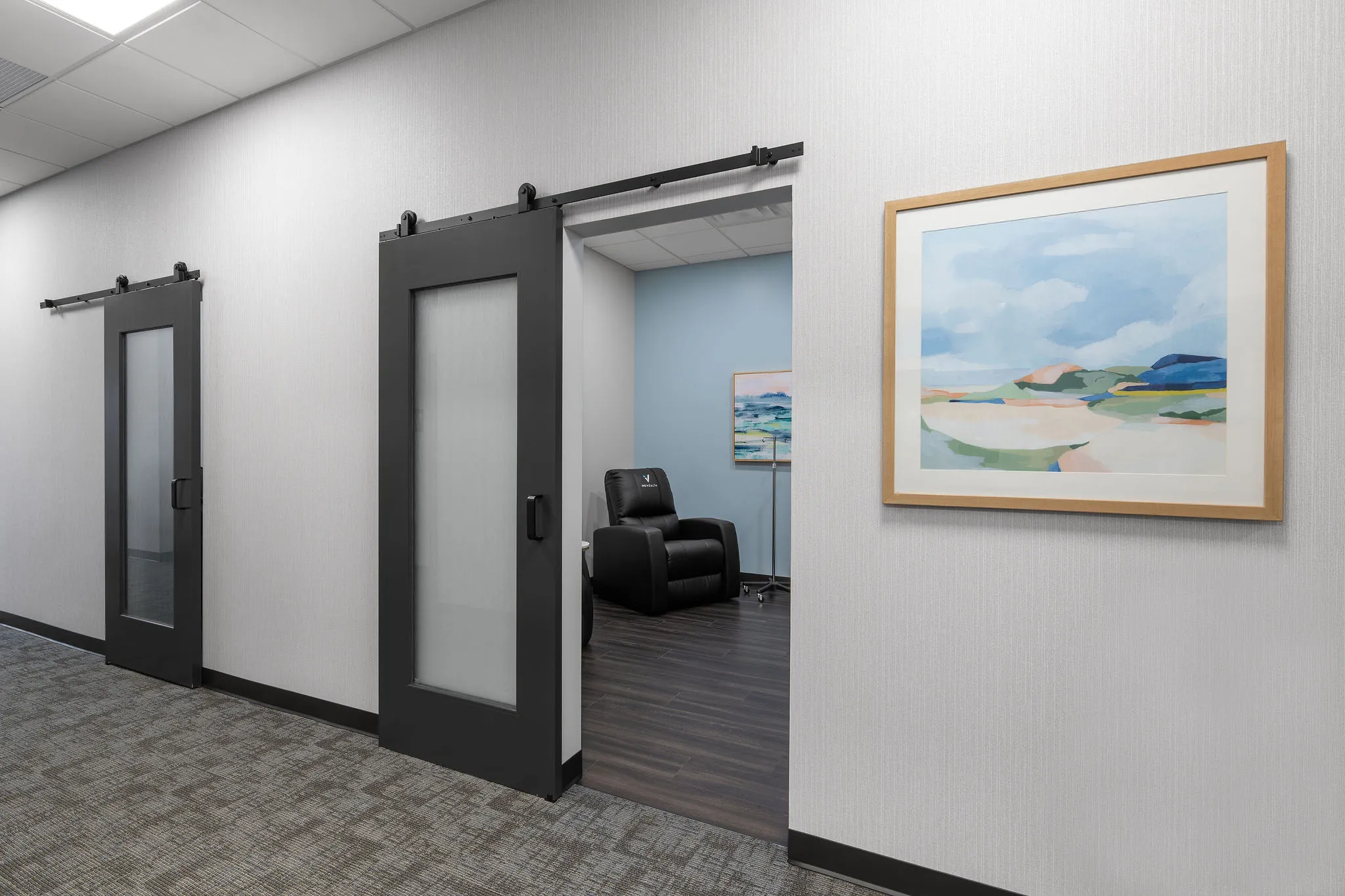 Corridor and treatment suite at IVX Health Crescent Springs, built by Perry Contracting.