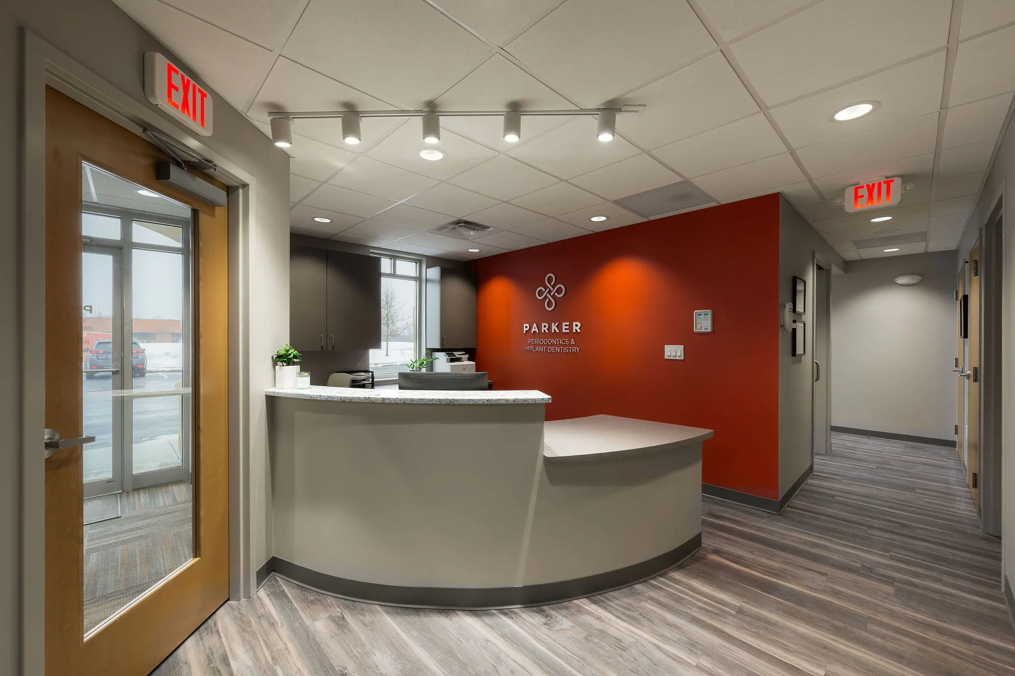 Reception and waiting area at Parker Periodontics, showcasing a modern dental office build-out by Perry Contracting.