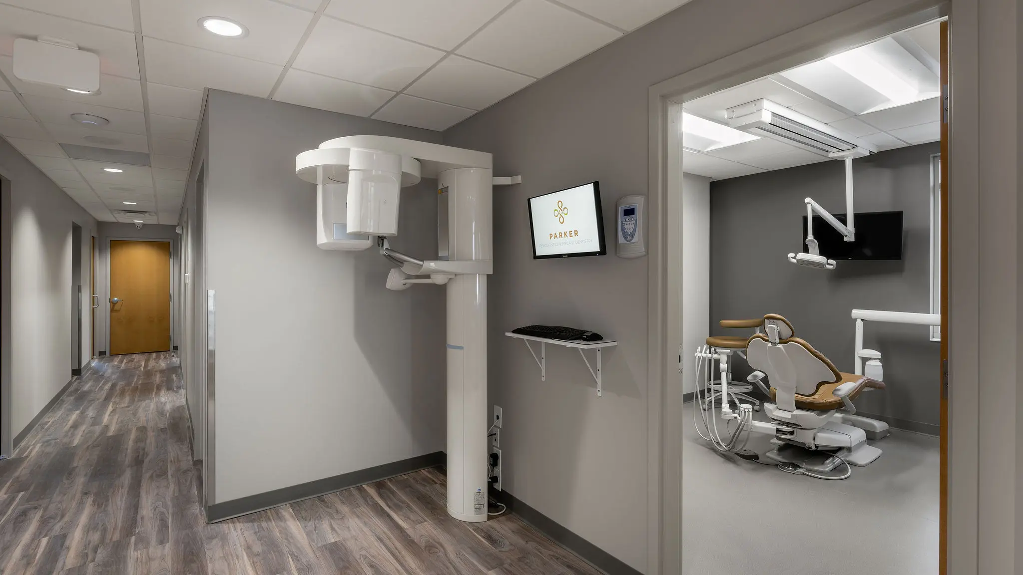 Clinical corridor and treatment rooms at Parker Periodontics, part of a full dental office build-out completed by Perry Contracting.