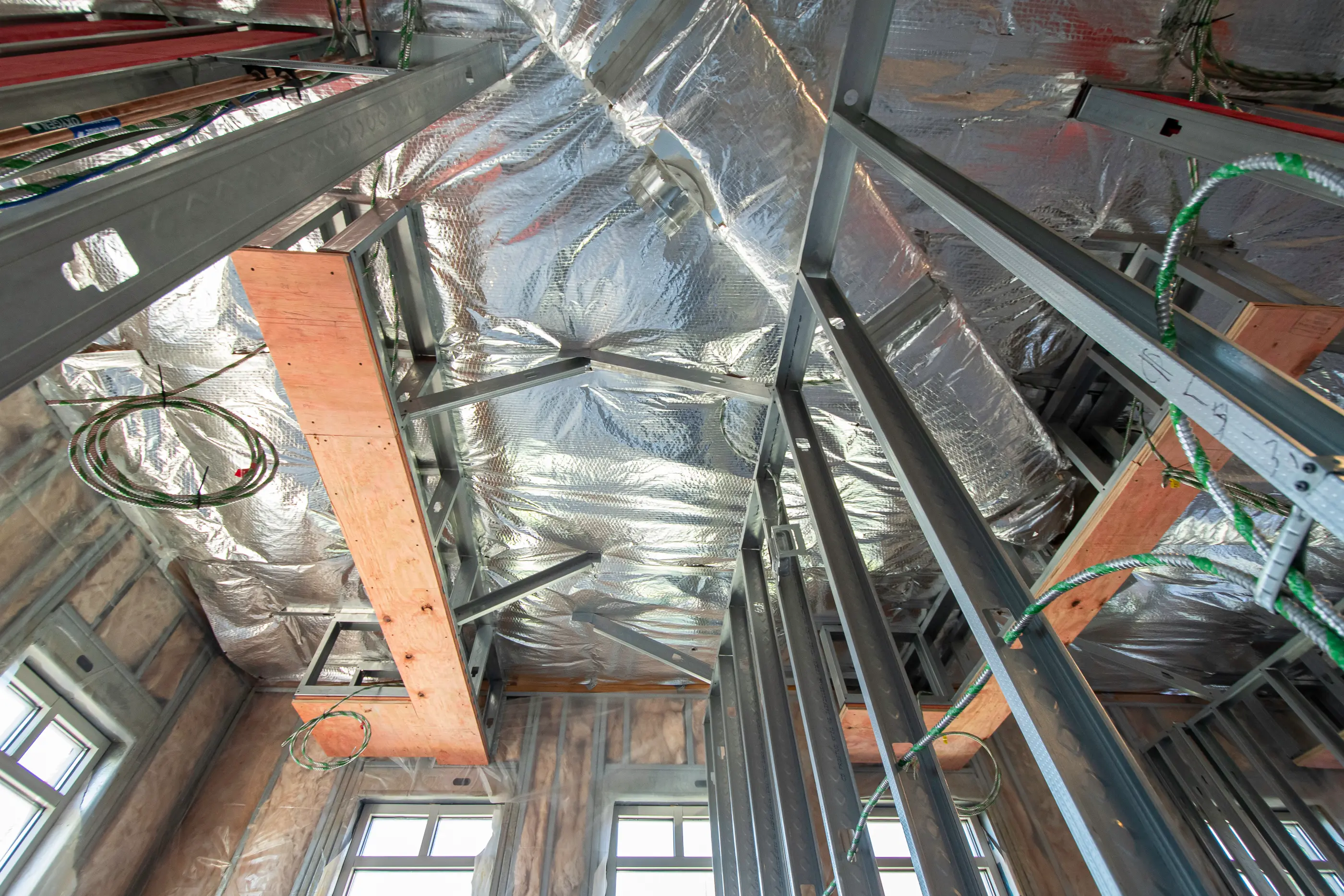 Ceiling grid installation in progress at Parker Periodontics, featuring overhead reflective insulation and mechanical rough-ins by Perry Contracting.