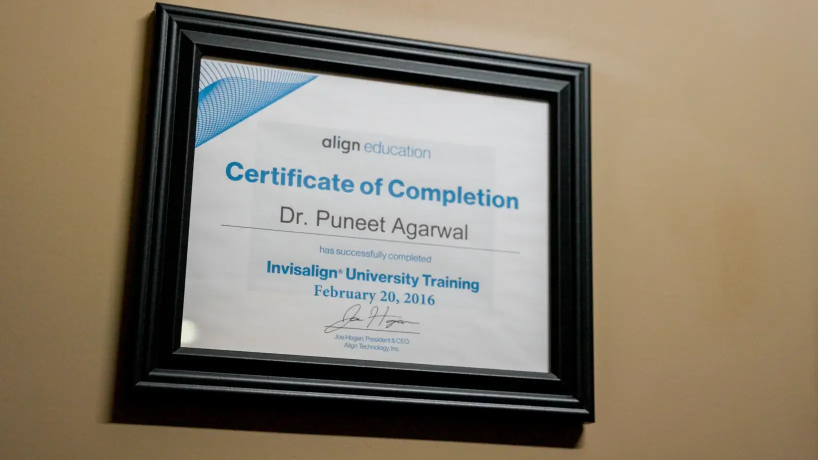 Framed certificate of completion for Dr. Puneet Agarwal from Invisalign University Training.